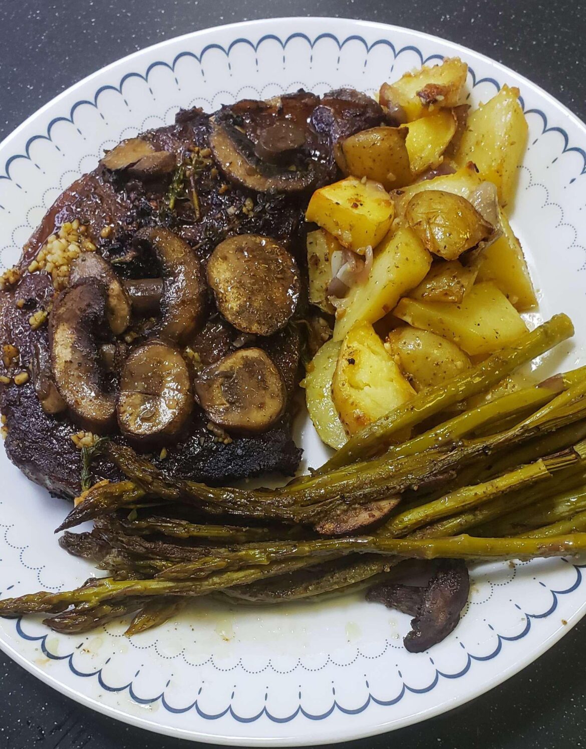 Steak and potatoes with asparagus and mushrooms