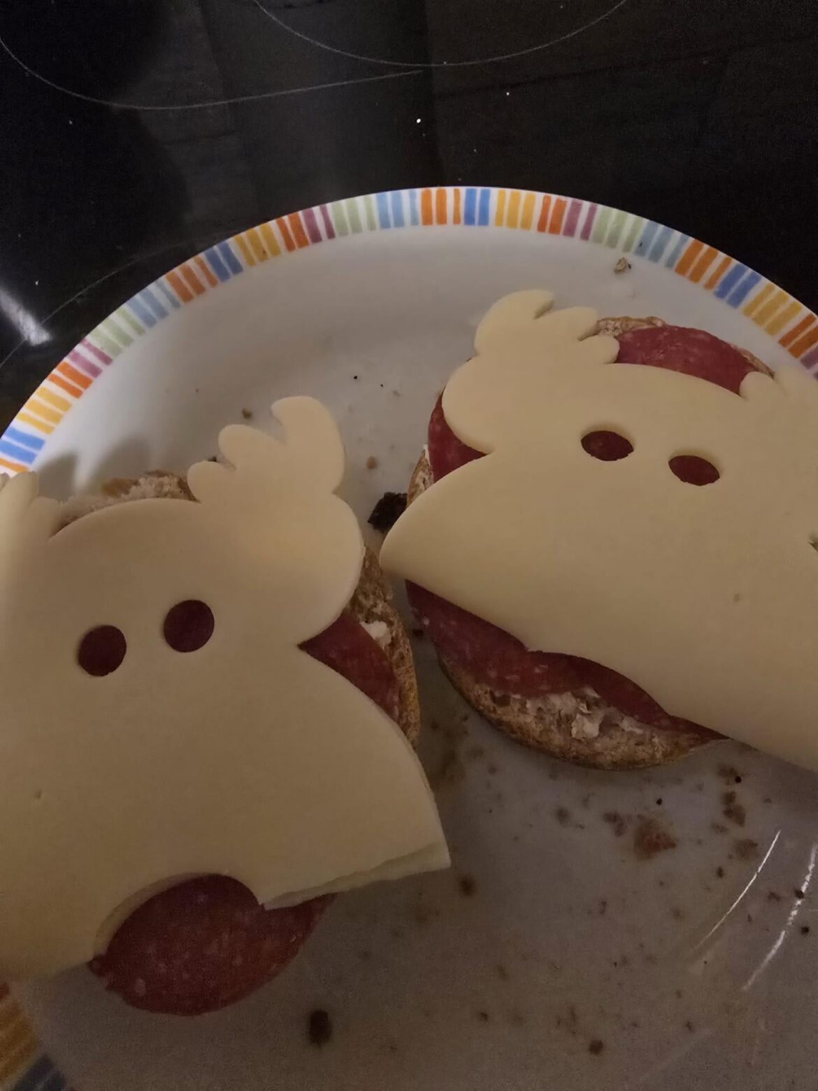 two slices of bread with salami and butter cheese