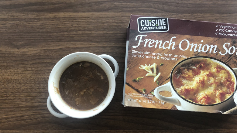 Cuisine Adventure French onion soup pack and bowl of soup on wood surface