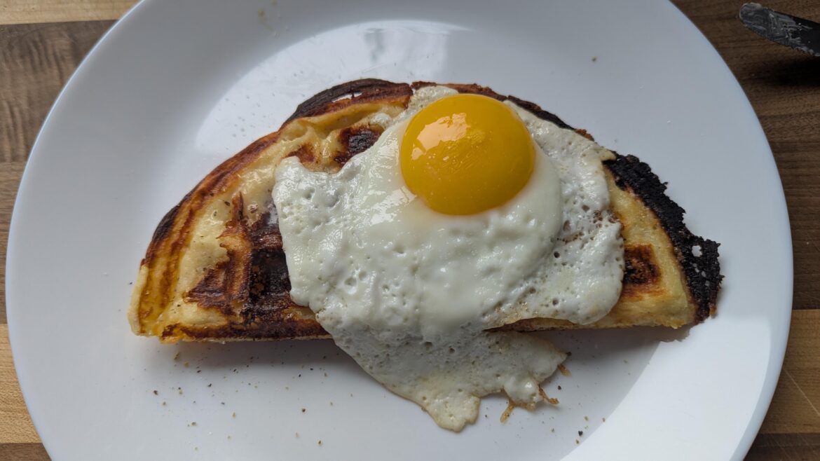 Sunny side up egg on a waffle mashed potato.