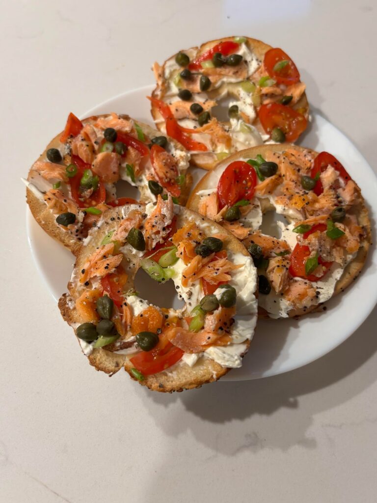 Cut a bagel into 4ths and topped with arctic char, tomatoes, scallions, cream cheese, capers, black pepper and a little lemon.