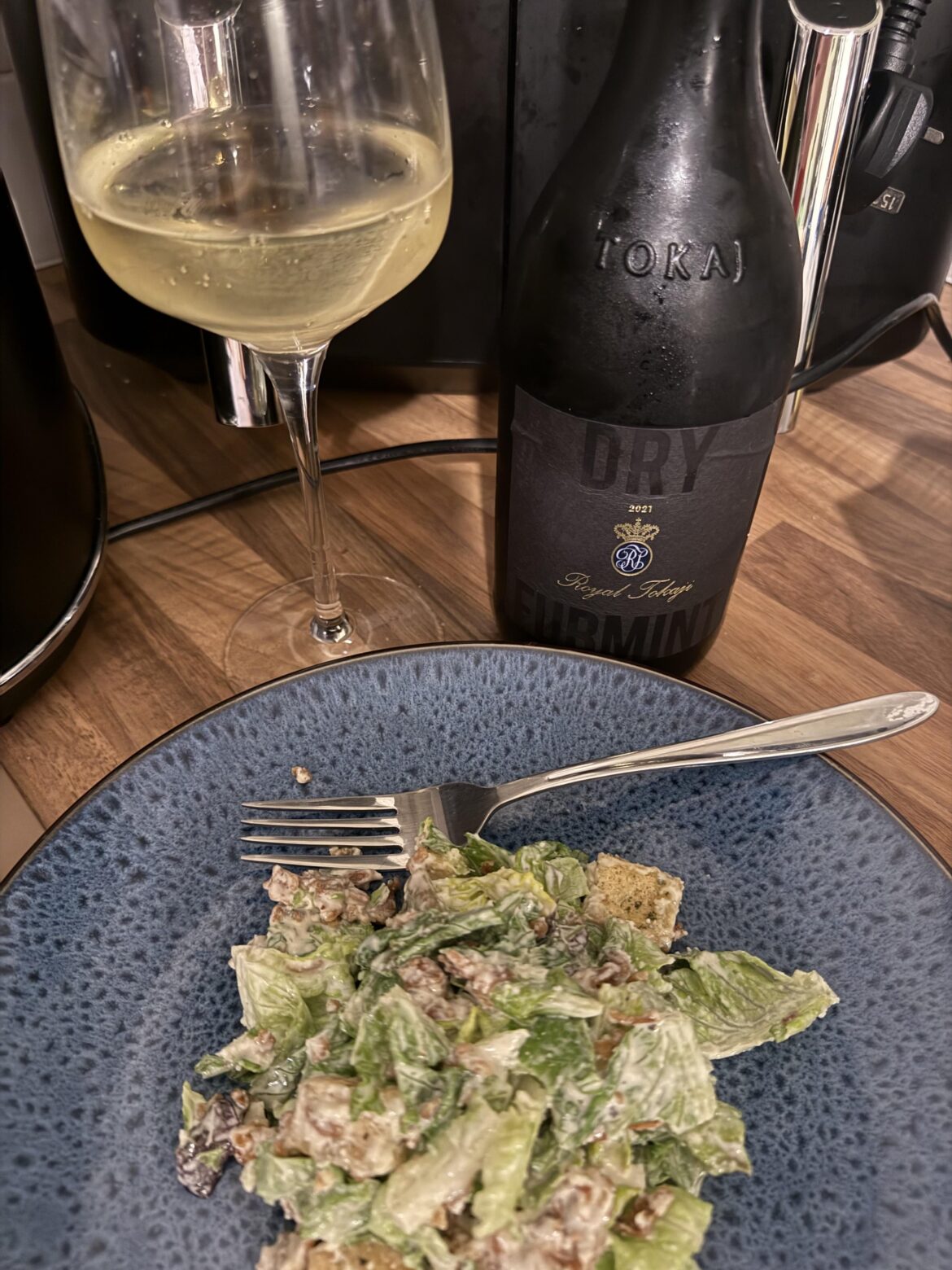 Caesar salad and a glass of wine