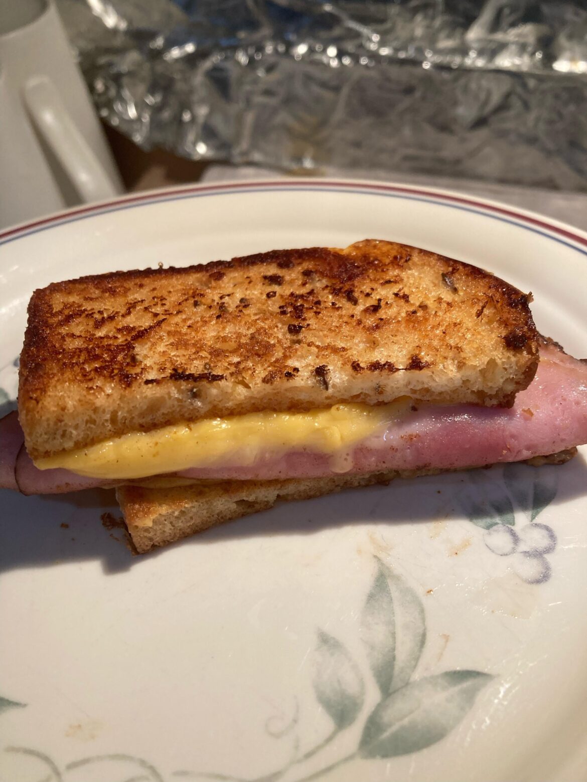 A simple half sammy melt. browned butter, deluxe american cheese, sautéed thin deli ham on seeded white bread... and love! :D
