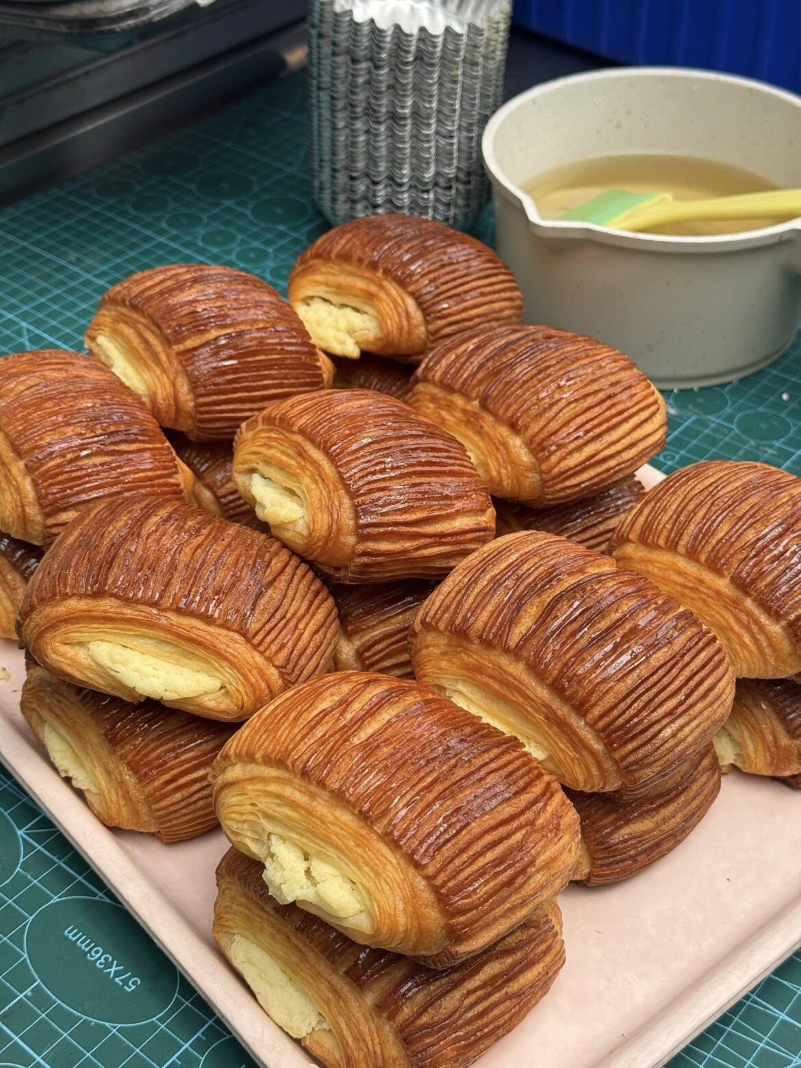 Homemade laminated pastry rolls with custard filling, fresh out of the oven