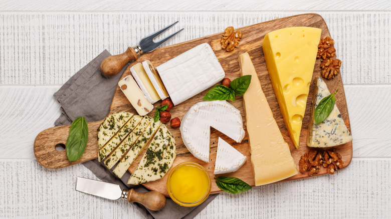 Assorted cheeses on a wooden board