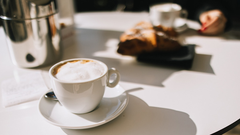 Milky cappuccino on table in a cafe