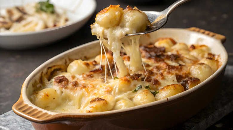 creamy gnocchi in bowl with spoonful