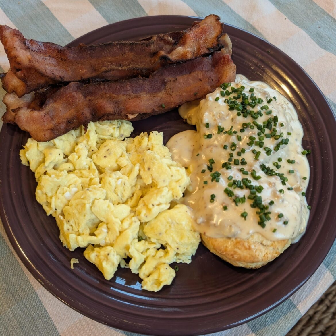 Biscuits and gravy, scrambled eggs, and bacon