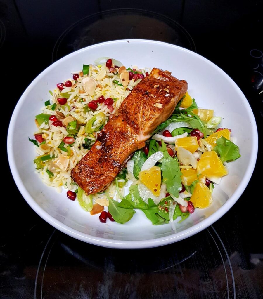 Pan Fried Soy Chilli Salmon, Jewelled Herb and Orange Rice and Fennel, Orange and Rocket Dressed Salad. Finished with Toasted Almonds and Pomegranate Seeds.