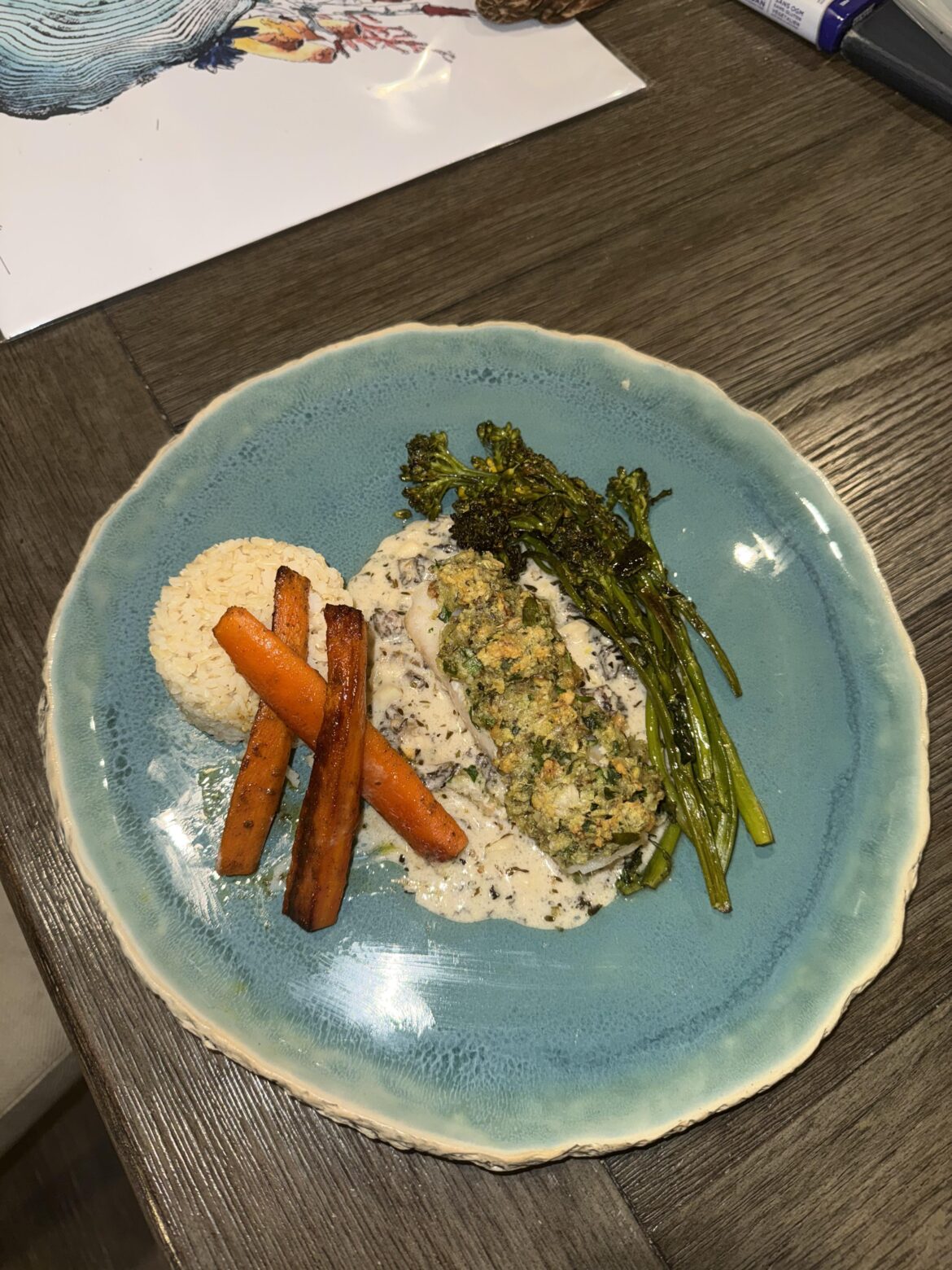 Herb and walnut gratin topped rock bass, maple carrots, broccolini, rice and a coconut morel mushroom sauce Herb and walnut gratin topped rock bass, maple carrots, broccolini, rice and a coconut morel mushroom sauce