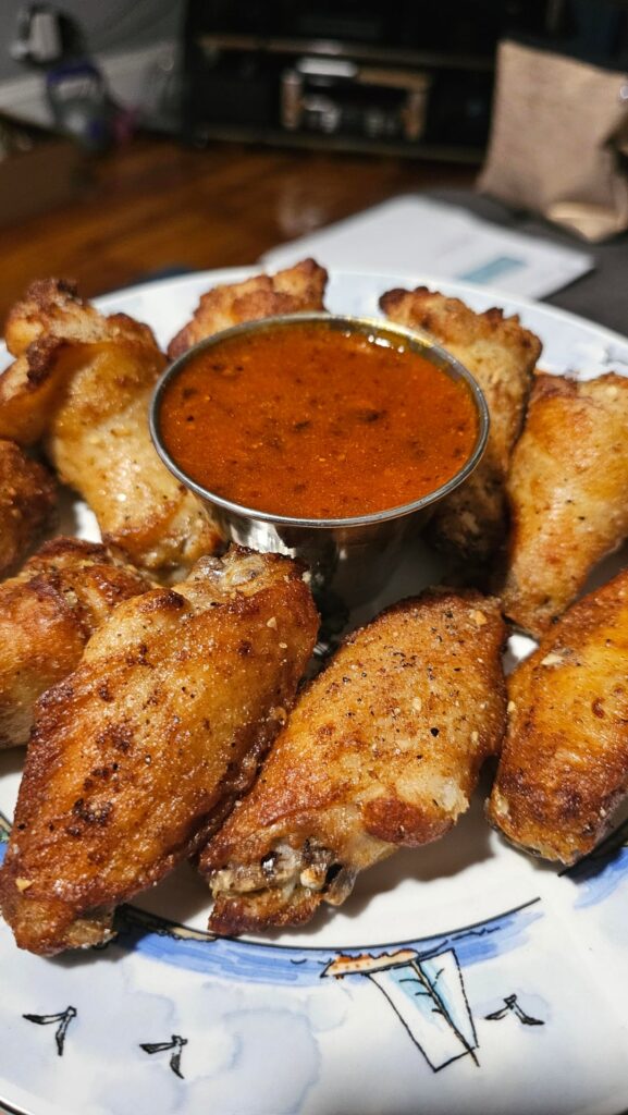 Crispy Air Fryed Black Pepper and Garlic Wings with a Home made Ghost Pepper Buffalo HOT Sauce with a Garlic Butter Base.. Slamming Good.