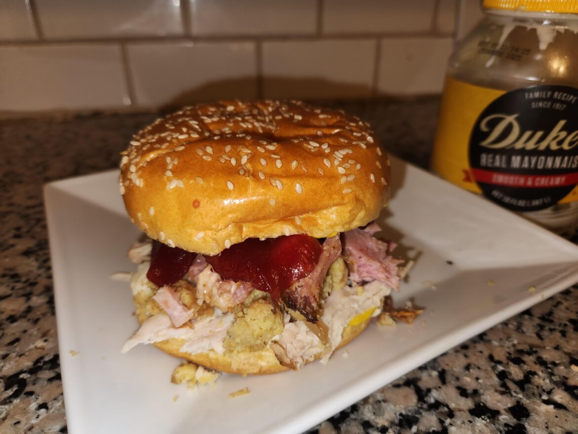 Duke's and mustard on the bun, then turkey, stuffing, honey ham, and topped with cranberry