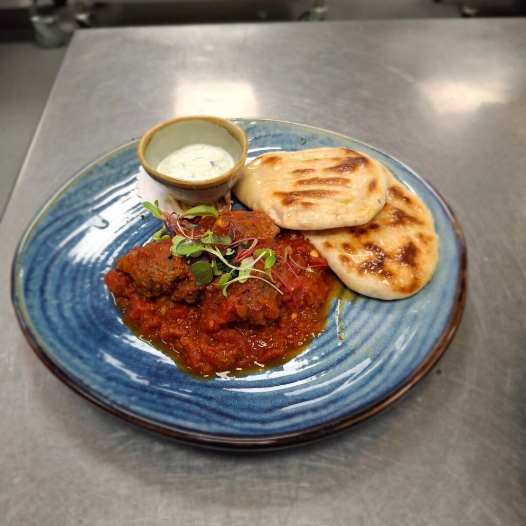 Spiced Lamb koftas in tomato sauce.