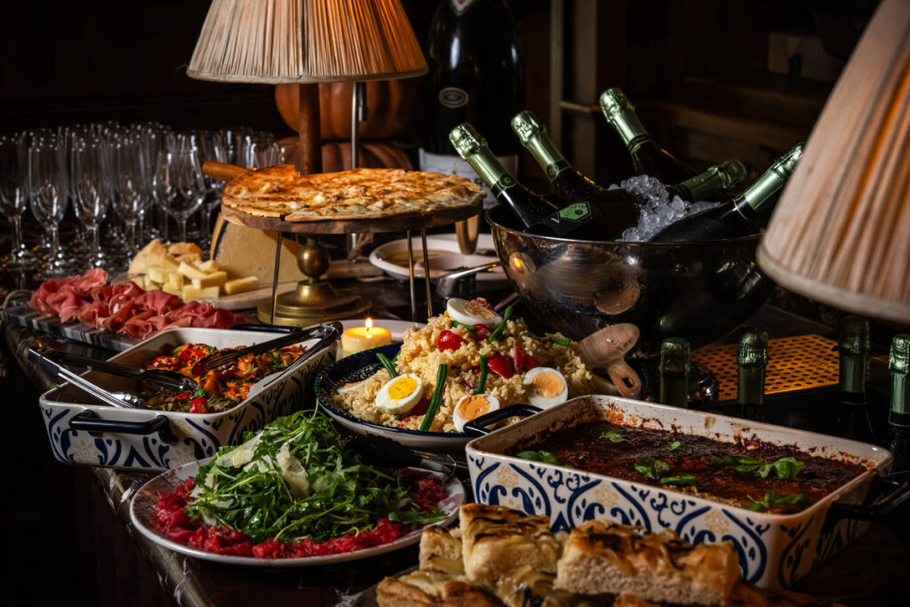 an indulgent buffet of italian food ranging from salads to filled flatbreads, aubergine parmigiana, beef, and more