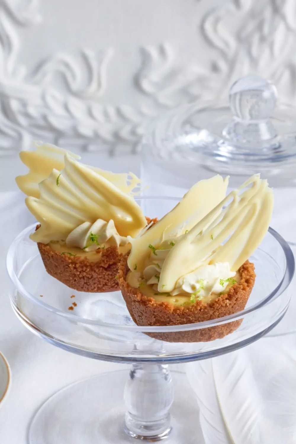 Mini lime pies with white tempered chocolate shards sticking out of it