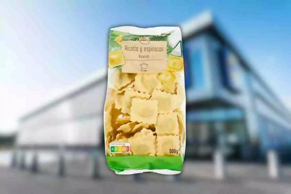 Package of ricotta and spinach ravioli in front of a blurry building.