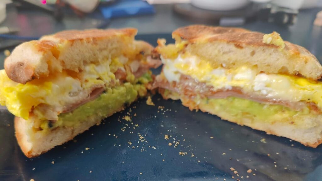 Cheesy egg, ham, avocado on English muffin