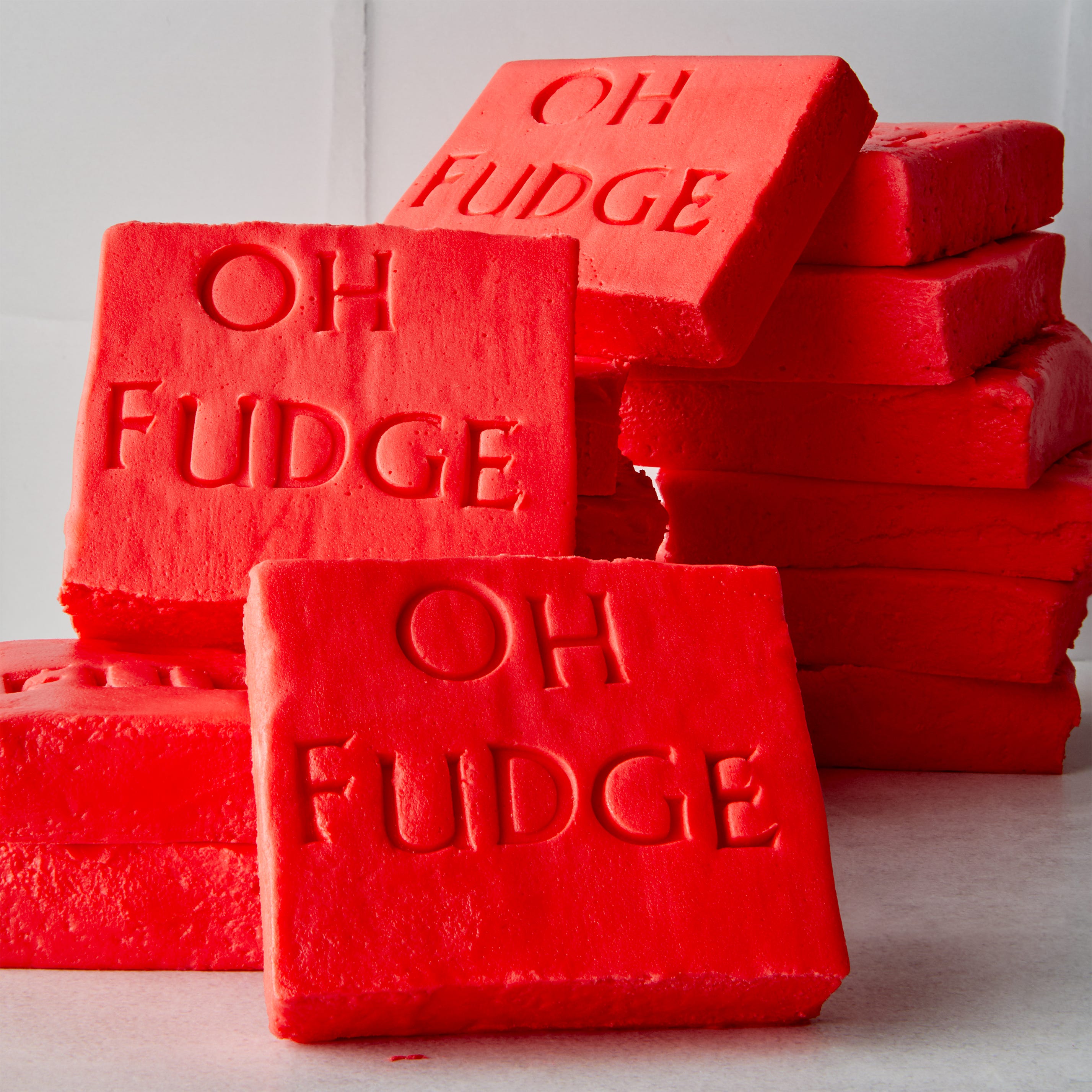 red fudge shaped like soap with the words oh fudge