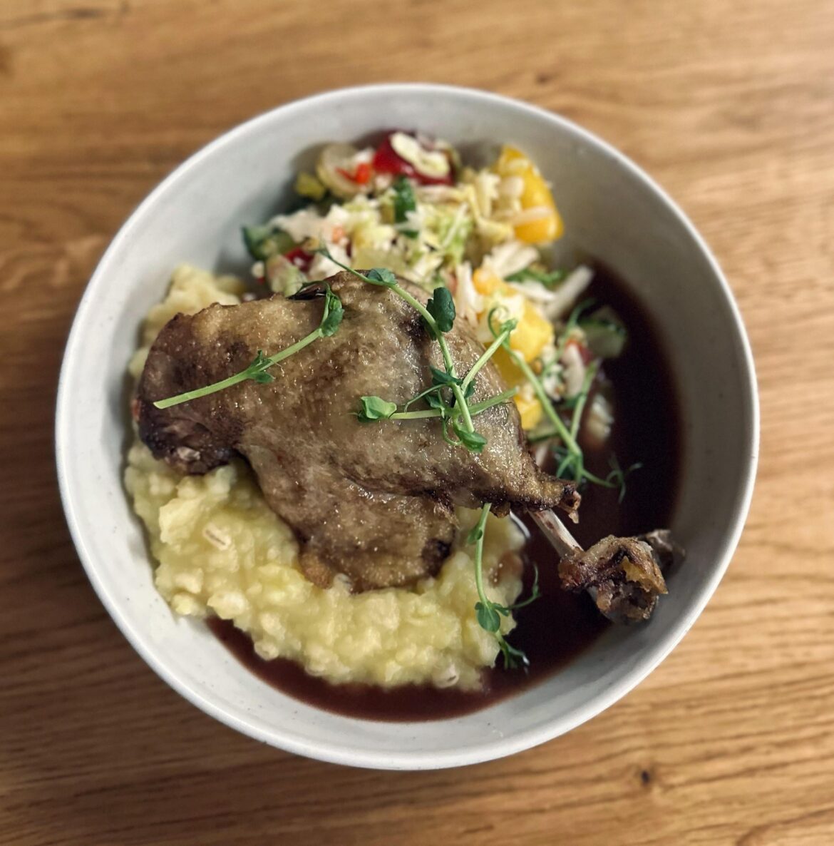 Oven baked duck, mashed potatoes with barley groats, salad and wine sauce