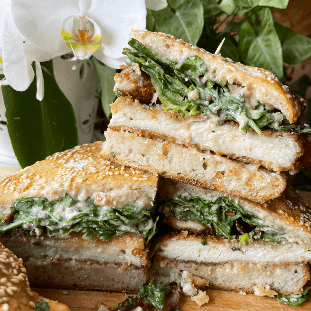 Fiancés new favorite sandwich I've been making lately: fried chicken caesar sandwiches. Fried chicken cutlets, bacon, homemade caesar dressing, salad mix, on a rustic sesame semolina loaf