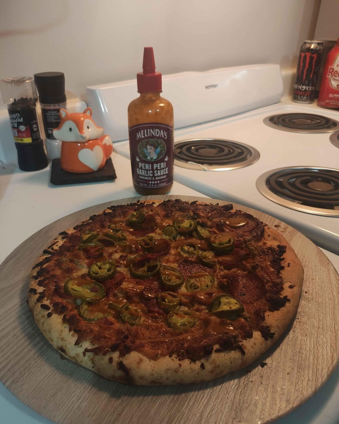 Homemade pizza with jalapeno slices and Melindas peri peri garlic