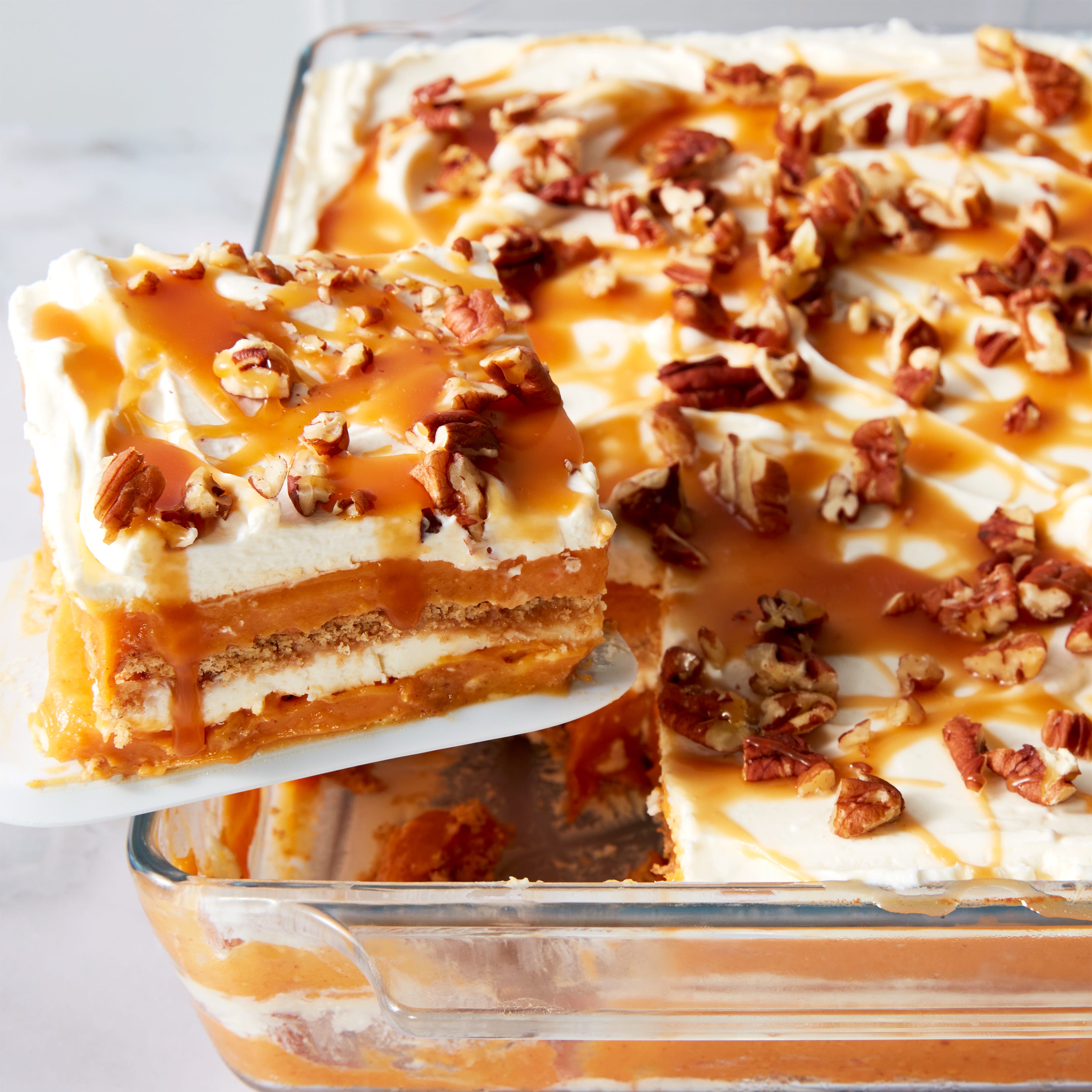 pumpkin cheesecake lasagna topped with pecans and caramel