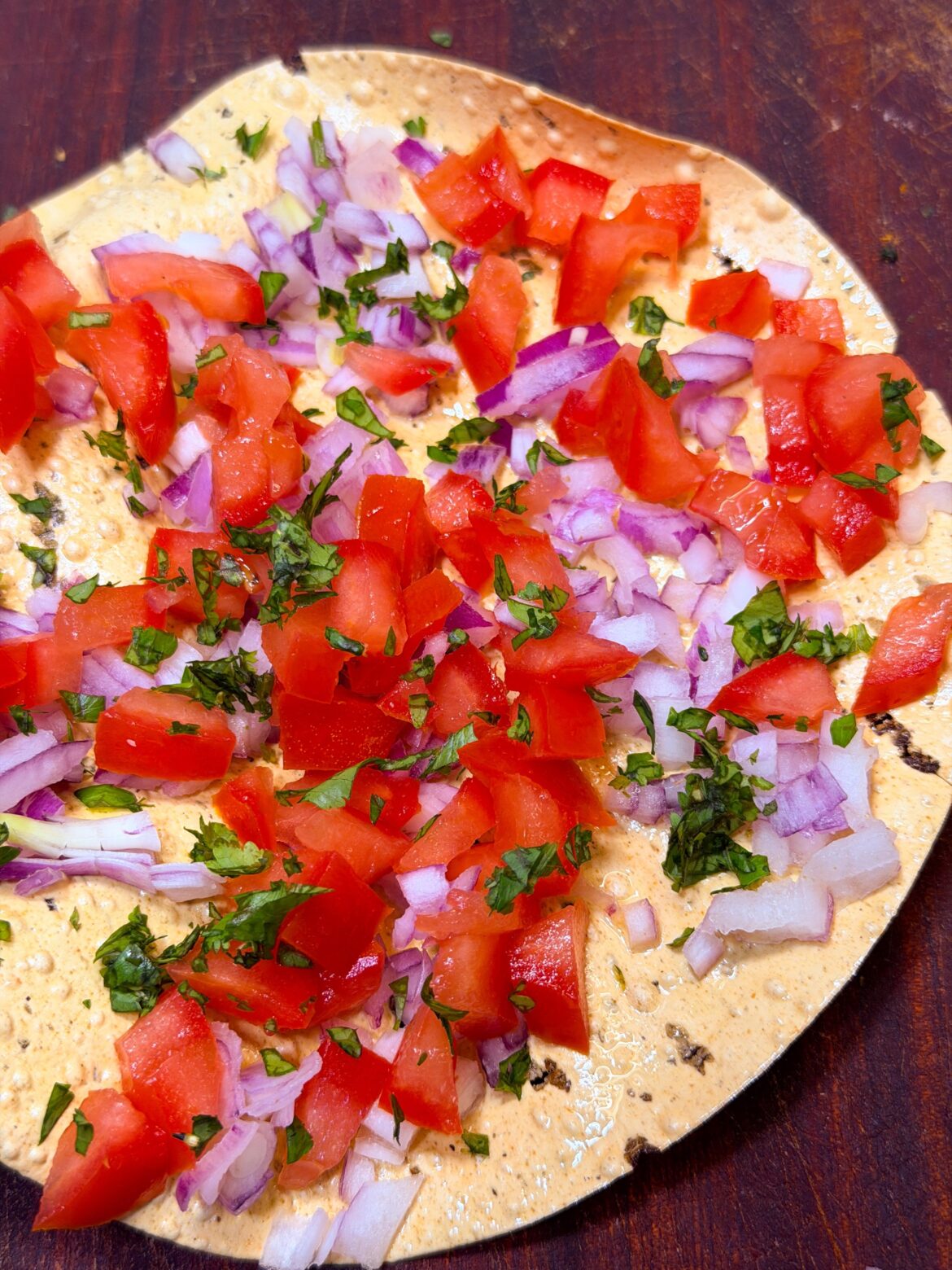 Air Fryer Masala Poppadum (Crispy Lentil Crackers) topped with onions and tomatoes