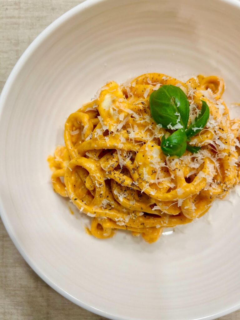 Paprika infused pasta with a creamy tomato and Parmigiano Reggiano sauce