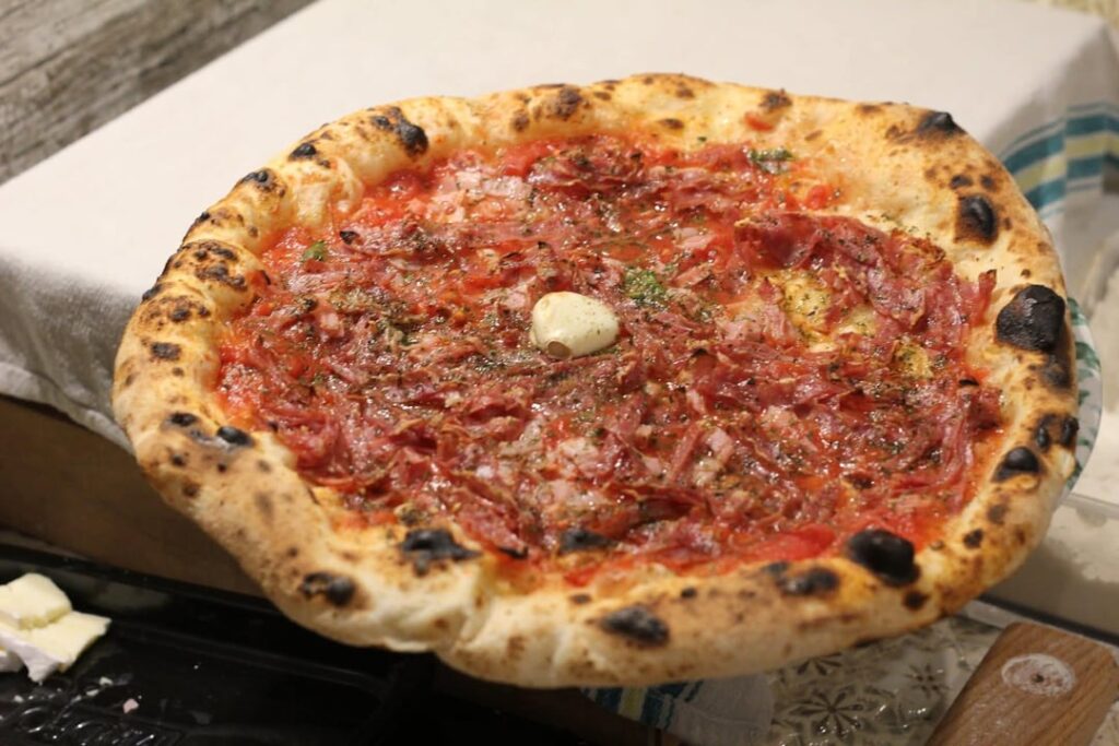 Pizza marinara with ham, salami
