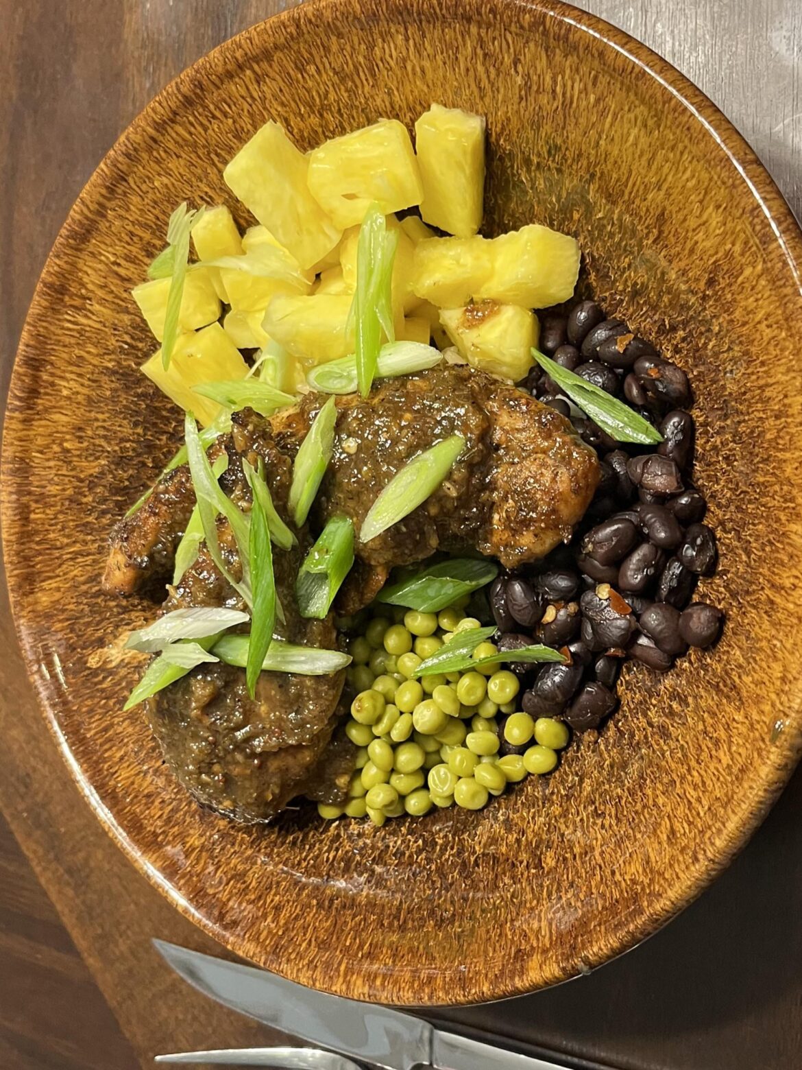 Jerk Chicken with rice, beans, peas, pineapple, and corn.