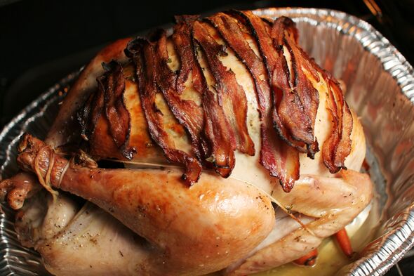 Roast turkey with bacon rashers laid across the top Roast turkey with bacon rashers laid across the top
