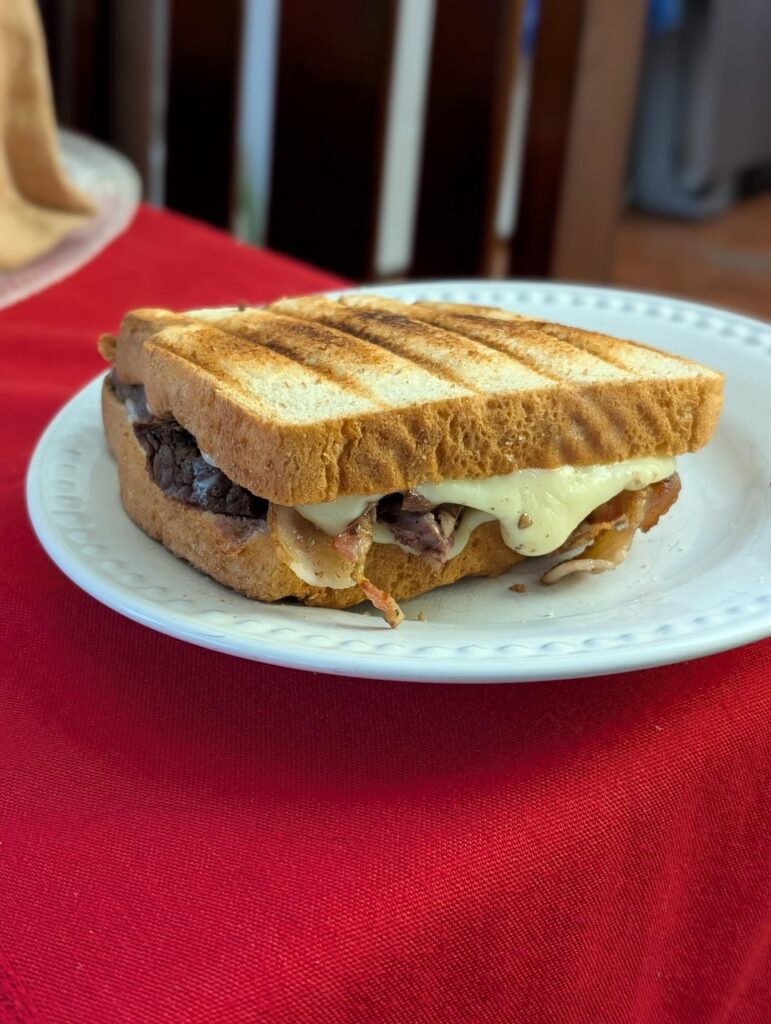 Filet mignon, little bacon, fried egg, white American cheese on honey wheat.