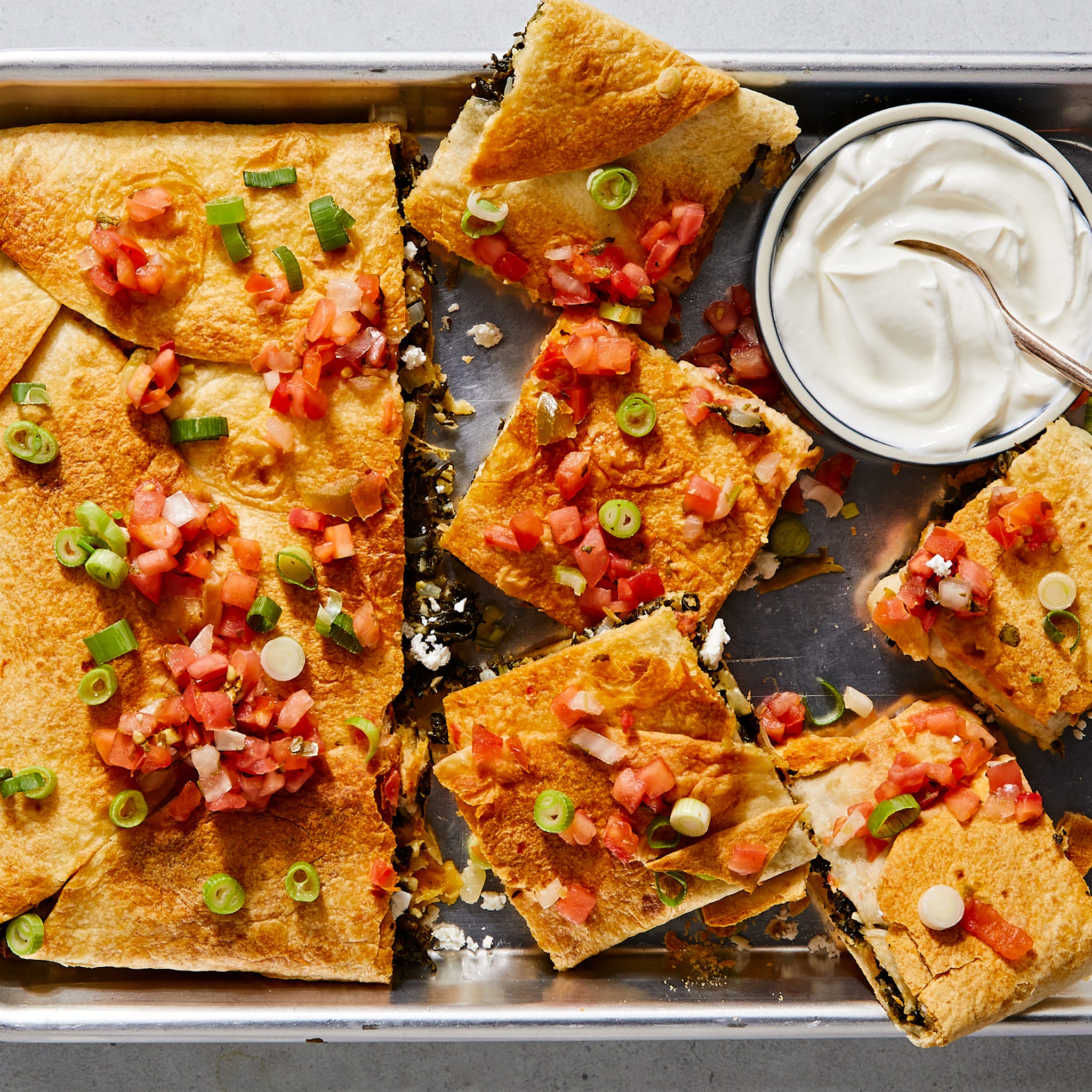 sheetpan spanakopita quesadillas with sour cream and diced tomatoes