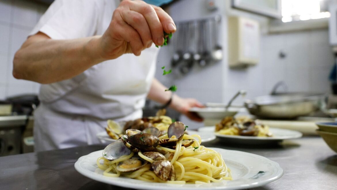 Italian cuisine granted world heritage status by UNESCO, as prime minister says honour ‘can only make us proud’ | World News A chef prepares spaghetti alle vongole (spaghetti with clams) in Rome in 2021. File pic: Reuters
