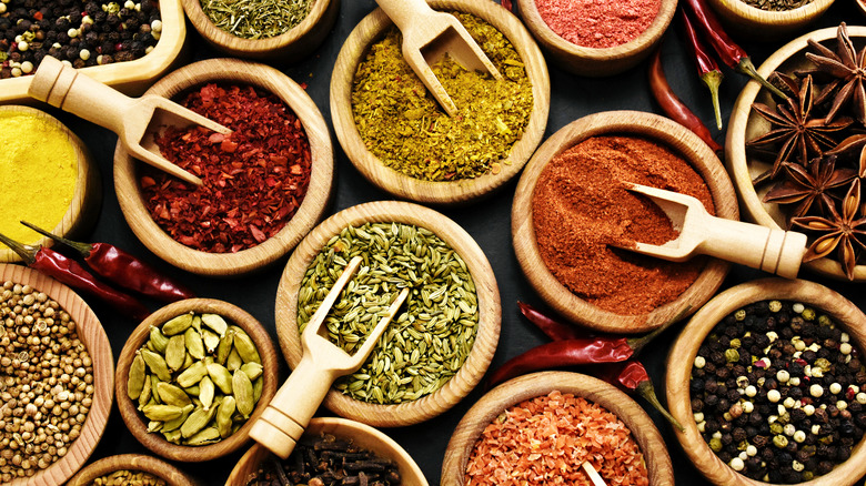 Wooden bowls filled with herbs and spices