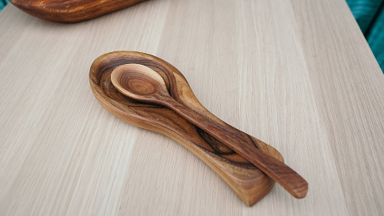 Wooden spoon on spoon rest