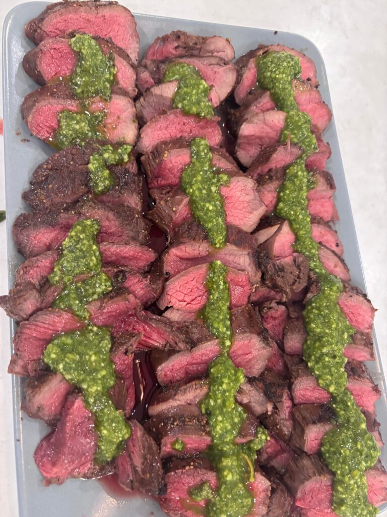 BBQ marinated venison with pesto sauce on top! Double baked potatoes as a side.