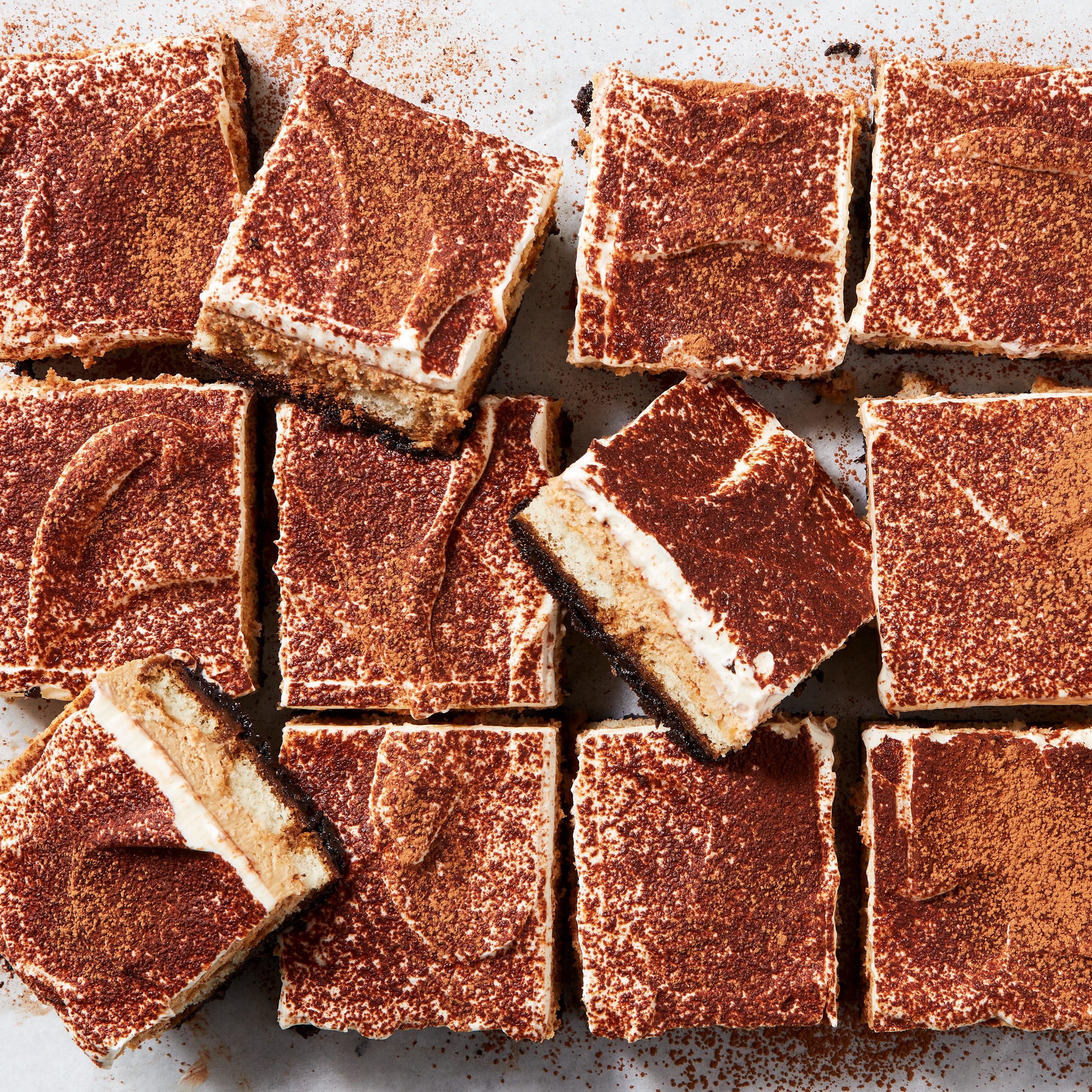 tiramisu cheesecake bars with espresso powder on top