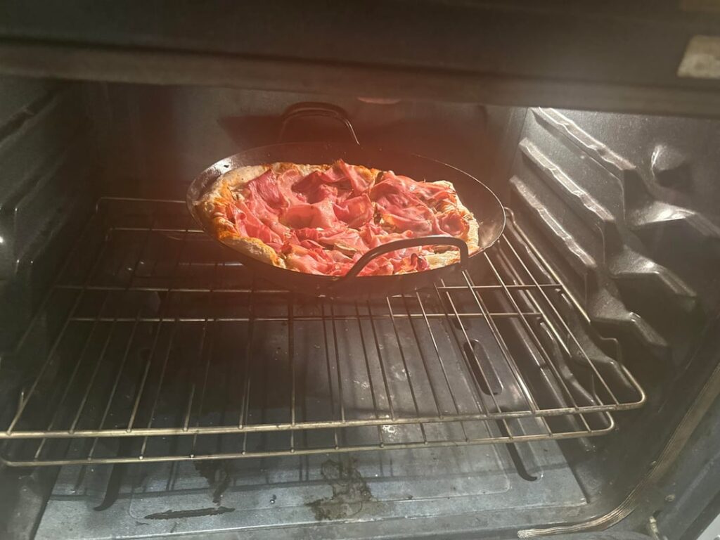 Hemispherical pizza Wok concave mushroom and prosciutto