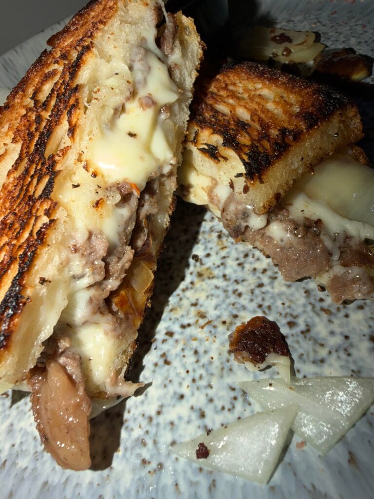 Grilled cheese with ribeye shavings and onion