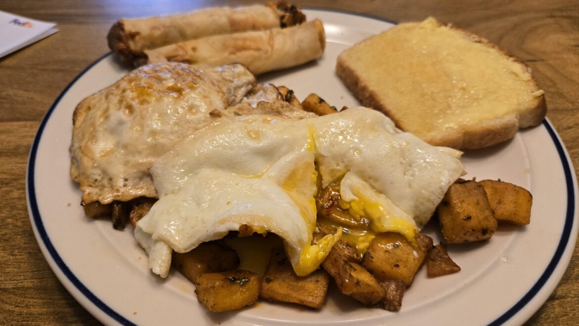 Fried eggs on potatas bravas