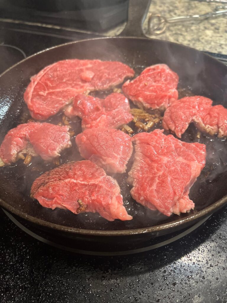 Steak and eggs. Steak cooked in onions and garlic butter.
