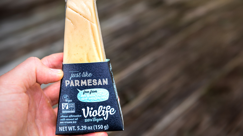 Person holding package of Violife Just Like Parmesan