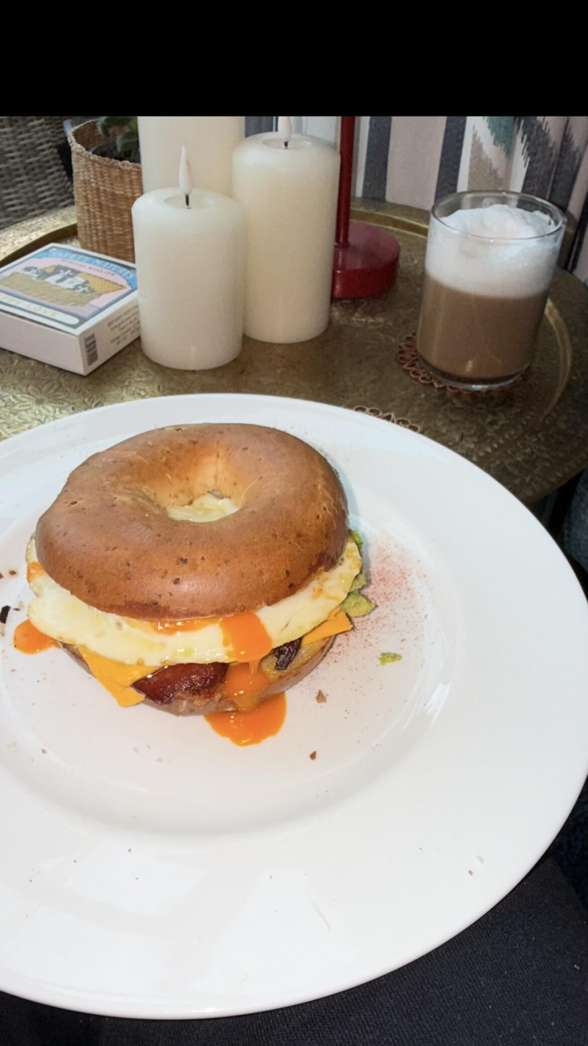 Caramelised onion everything bagel sandwich. Contents: golden yolk egg, avocado, crispy maple bacon,cheese. (Homemade vanilla latte) ops ?
