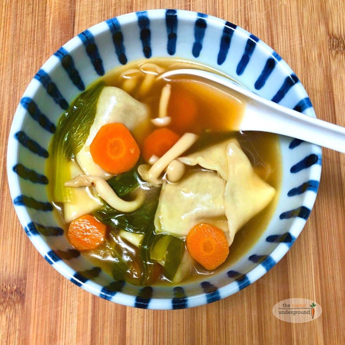 Vegan Wonton Soup 🥣 homemade wontons bok choy, mushrooms, & carrots simmered in a rich broth.