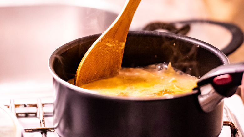 Stirring pot with wooden spoon