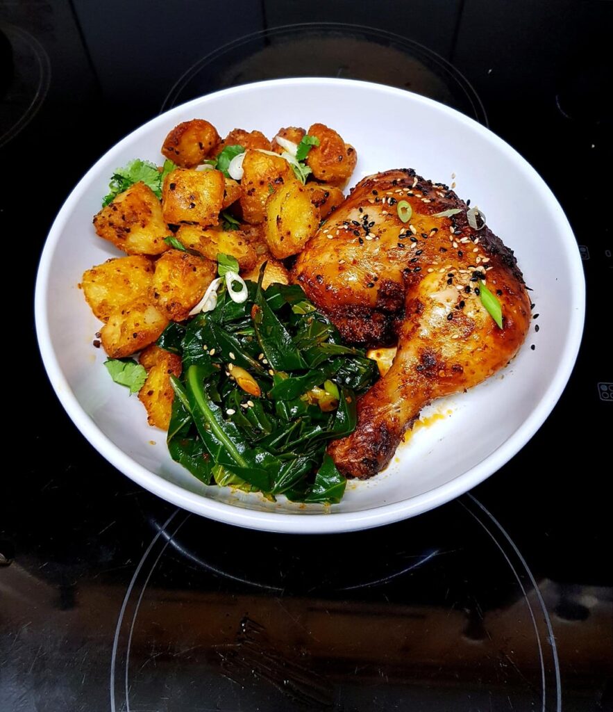 Gochujang Roast Chicken, Roast Potatoes with Herbs (and a Dip) and Korean Style Greens. Finished with Sesame Seeds.