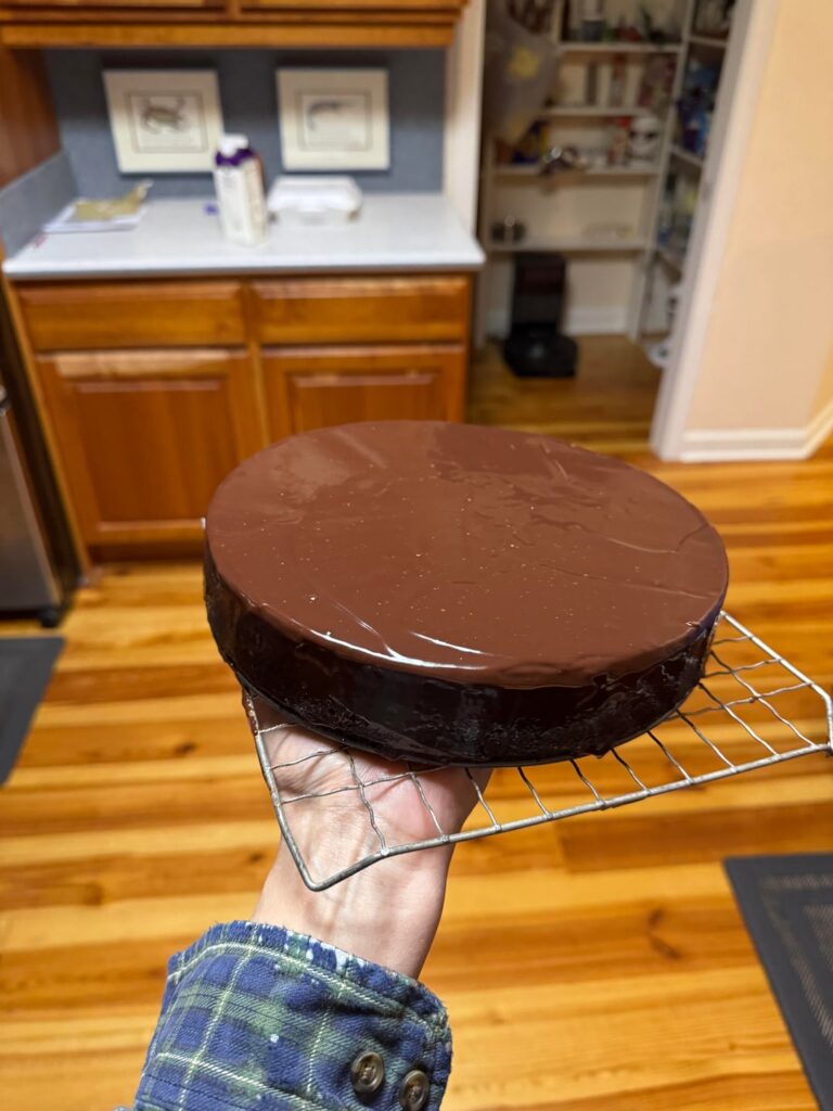 She’s done. She’s a beaut. Covered in ganache. Daughter made a choc mousse- will probably top it with that, too. Chocolate peppermint cheesecake. Supposed to cover with chopped candy cane but I can’t do it.