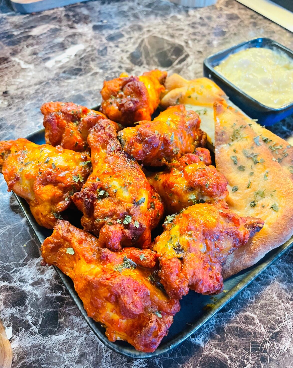 Homemade Buffalo wings, side of pita bread.