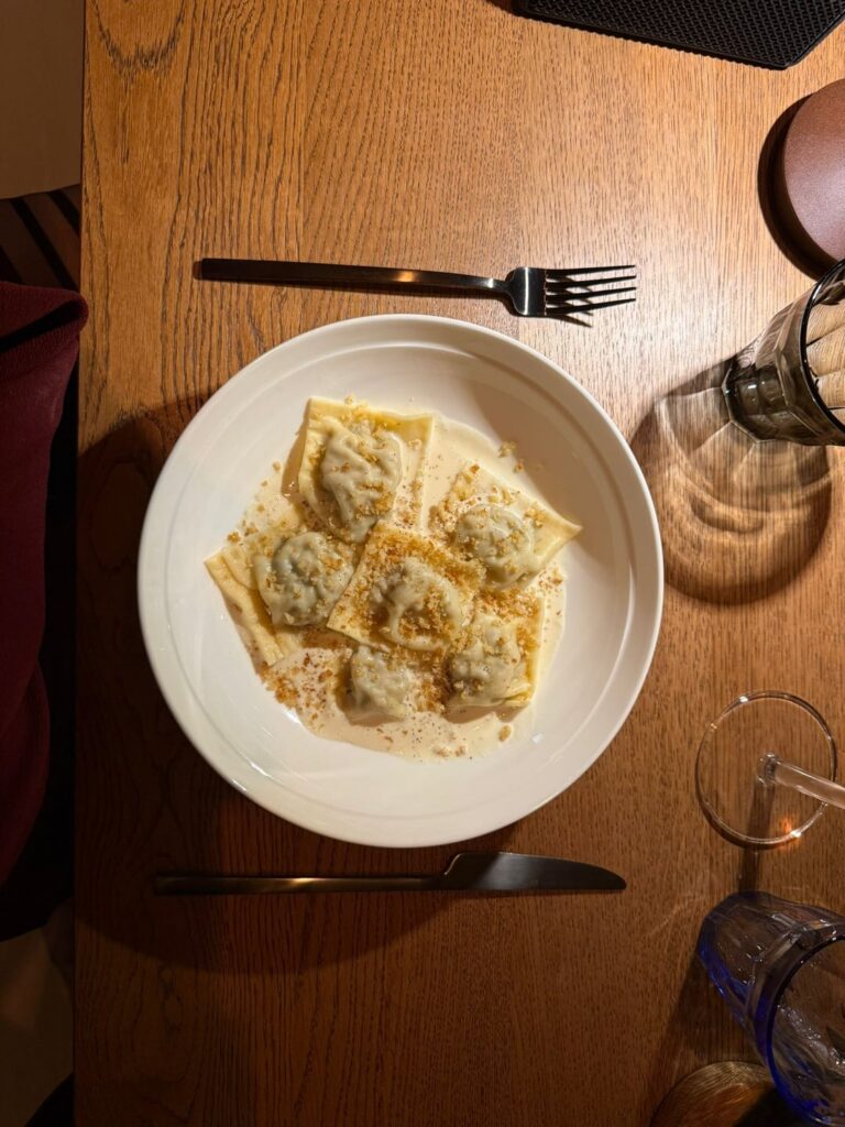 Agnolotti piemontesi with parmezan cream and baked bread crumbs